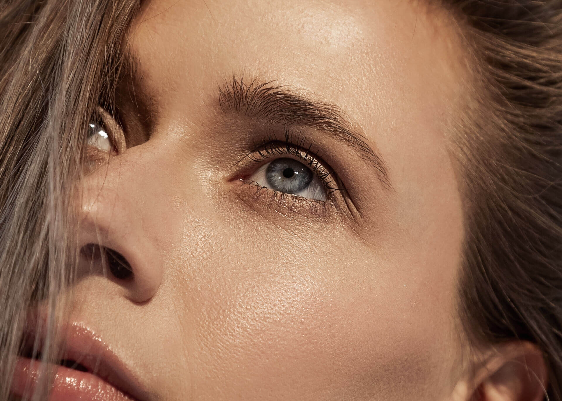 a close up of a young woman's blue grey eyes