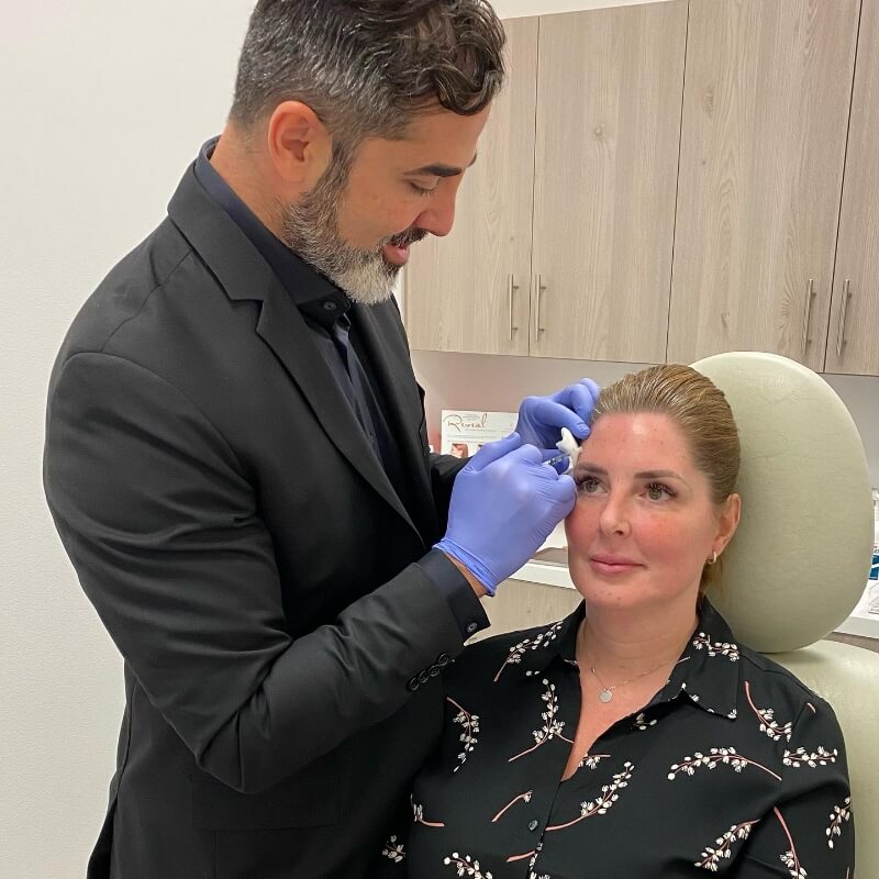 Dr. Mehdi Sina with a patient having a facial injectable treatment