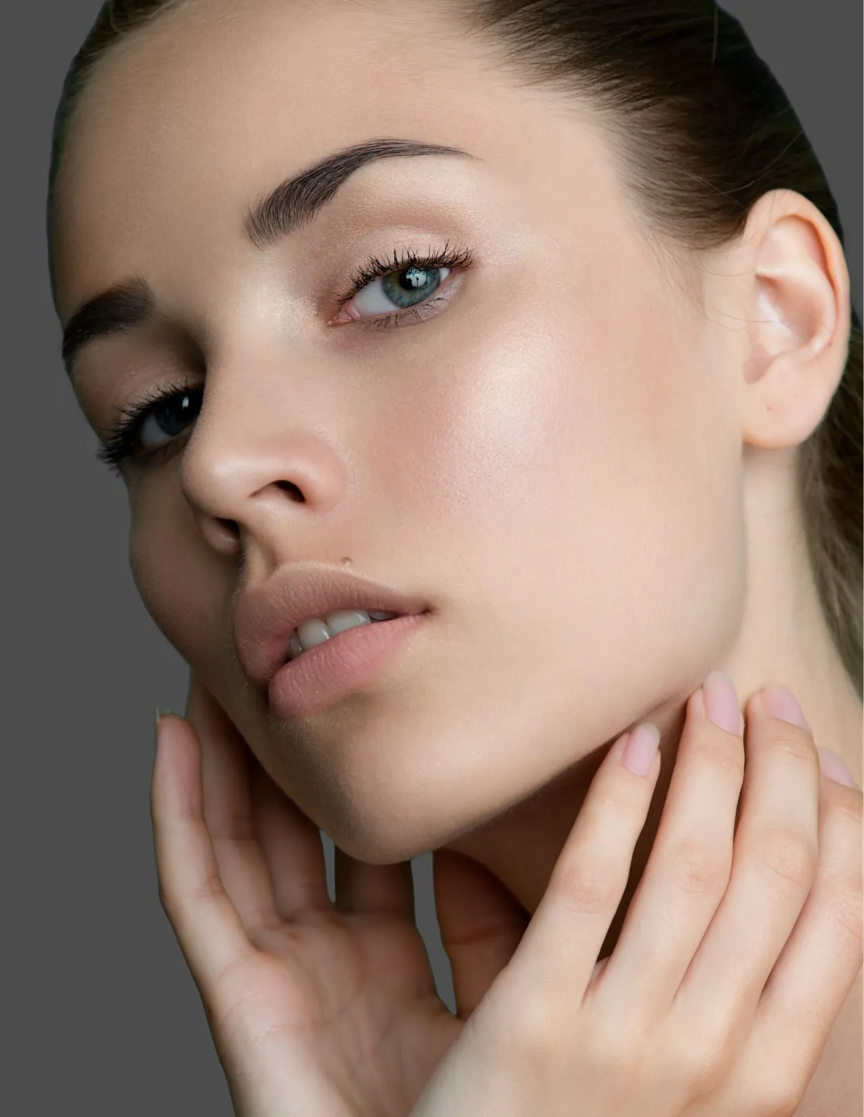 a young woman with blue eyes, touching the side of her face with her head tipped back